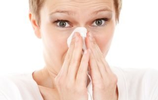 Woman sneezing from allergies