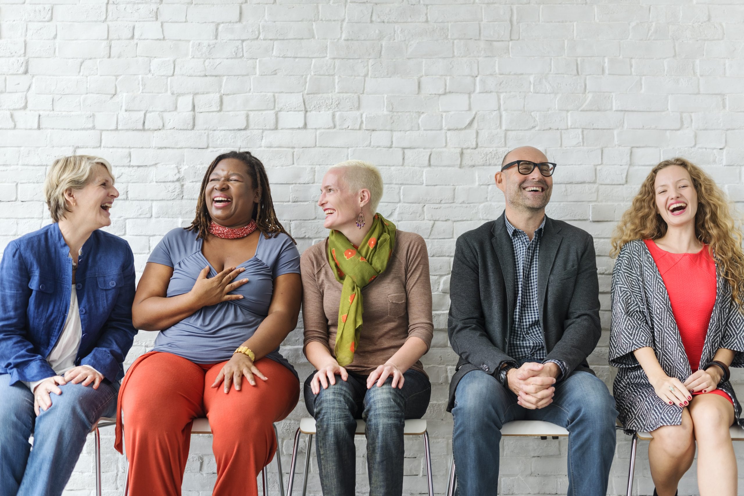 Happy group of diverse people seated, laughing