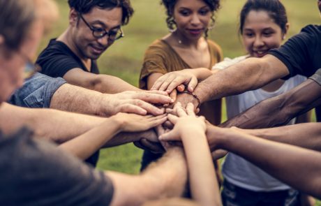 Group of people stacking hands in a circle